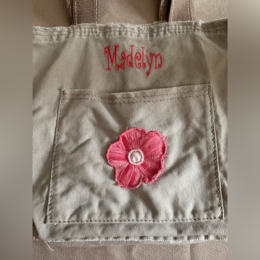 Thirty one tote with Madelyn embroidered on outside.